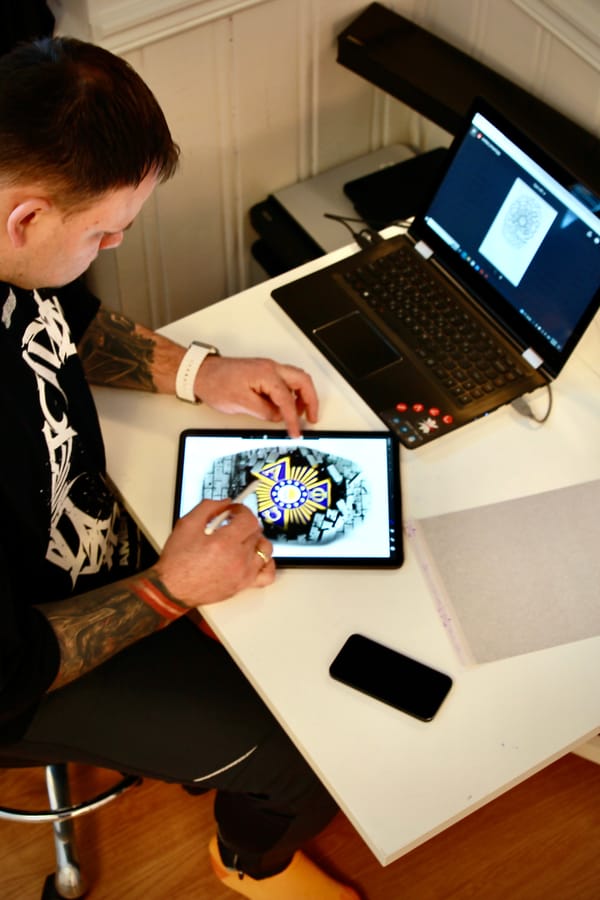 Ed tattooing on client arm close up